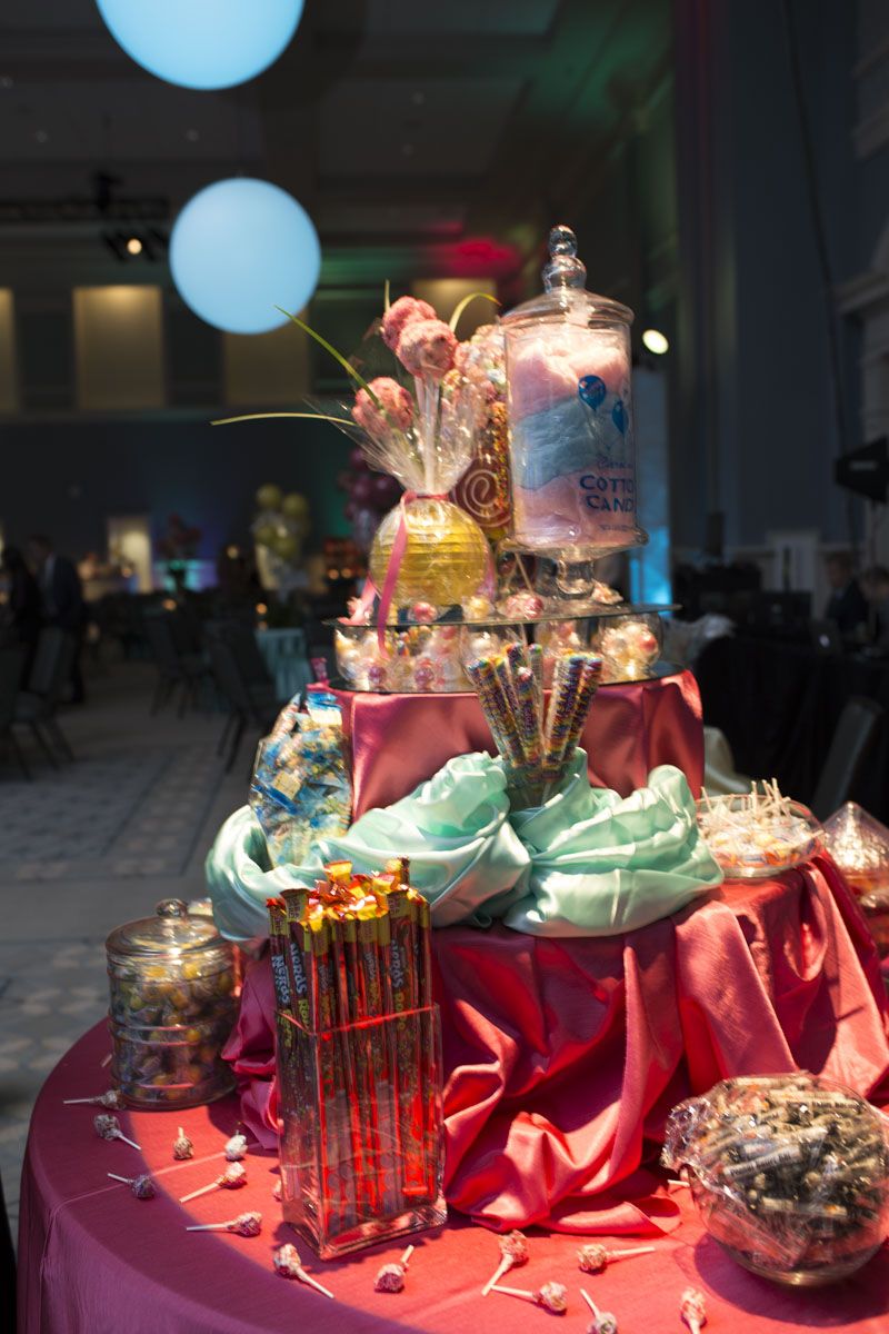 Jars of candy lined two tables letting guests have access to sweet treats throughout the night.