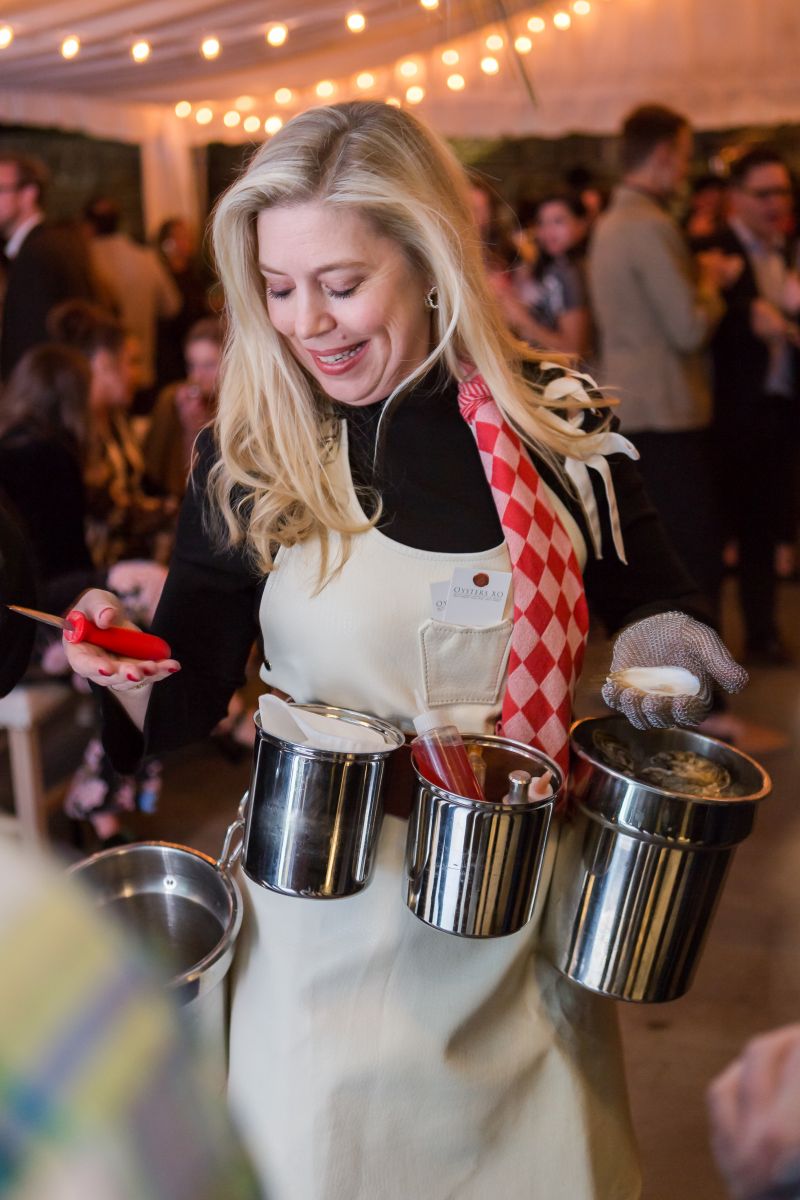 Lydia Mondavi helps guests shuck oysters