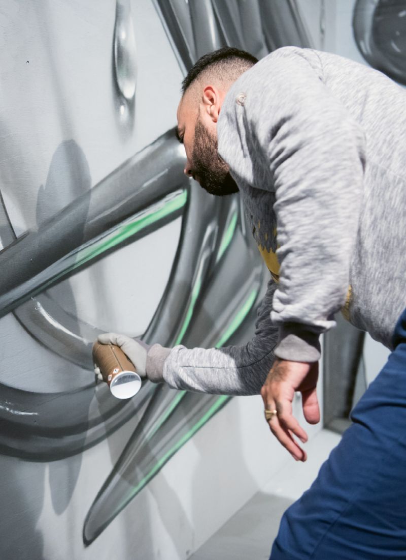 Odeith adds the finishing touches to his artwork.
