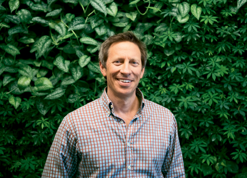 Green Roof Outfitters founder Michael Whitfield in front of a green wall that uses the company’s modular system