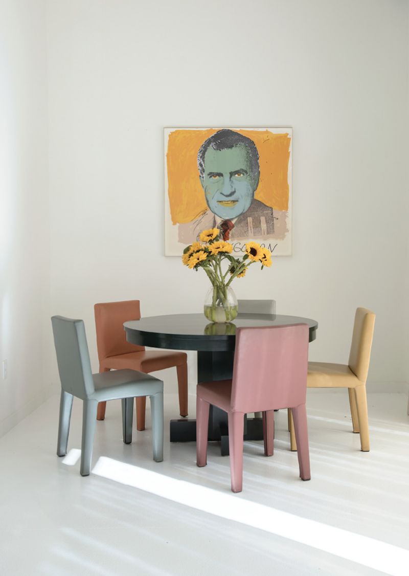 COLORFUL FRIENDS: Baldwin recalls hanging out with Andy Warhol in New York in the ’70s, and one of his original screen prints of Richard Nixon hangs above a lacquered green Roy McMakin table in this sitting area. Vintage Donghia leather chairs share the sunlight that streams in from the floor-to-ceiling windows.