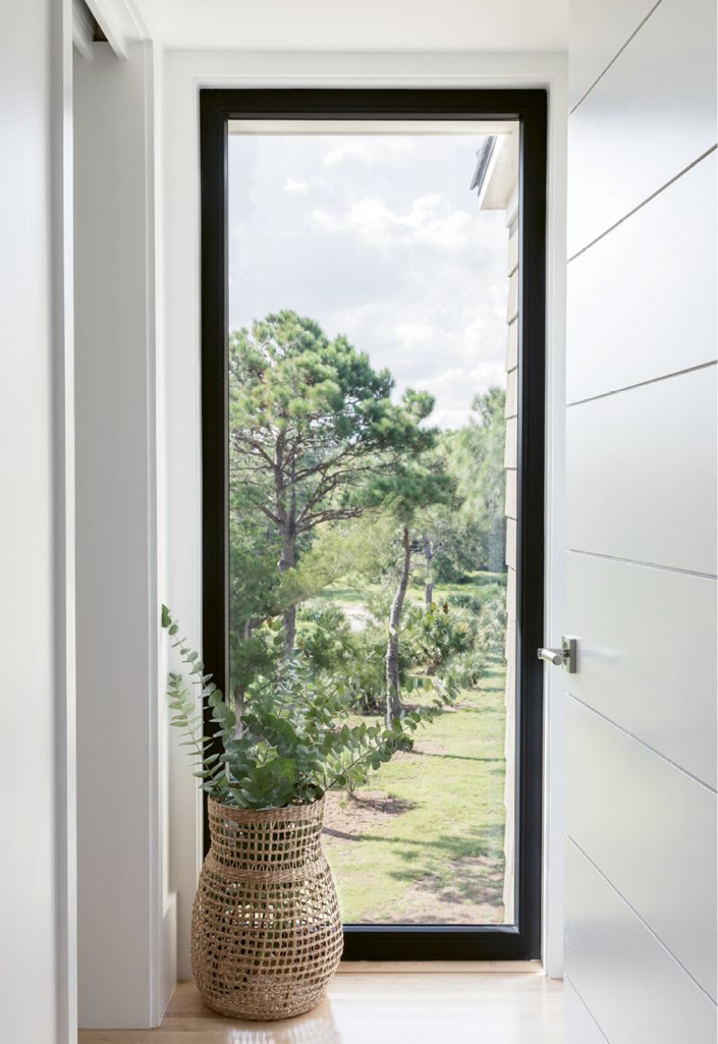 ARTFUL LANDSCAPE: When given a choice of a blank wall or window, the Newmans choose the latter every time. “We actually gave away or sold a lot of our artwork because we simply don’t have much wall space,” says Heidi. “The view is the art.”