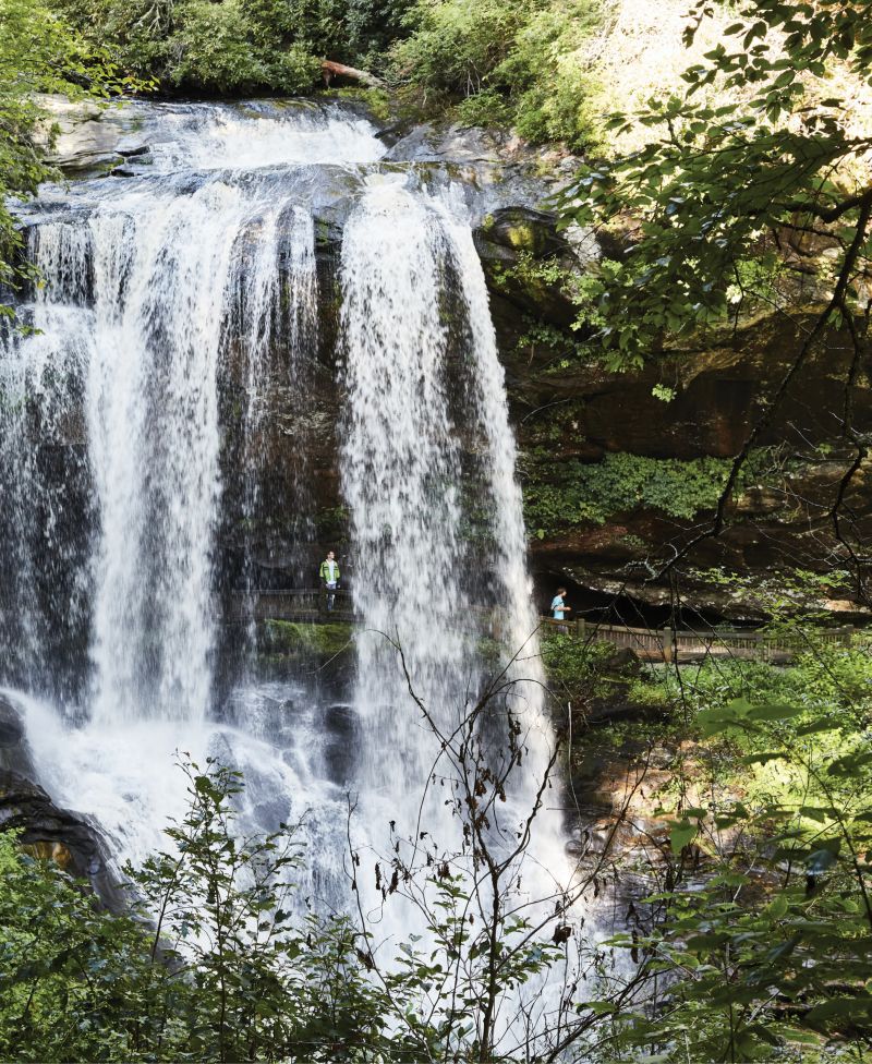 Cool Mist: Visitors follow the trail behind the cascading water at Dry Falls in Highlands, North Carolina. (Opposie) Courtyard doors to guest rooms at the newly renovated Skyline Lodge, a few miles from the small town center.