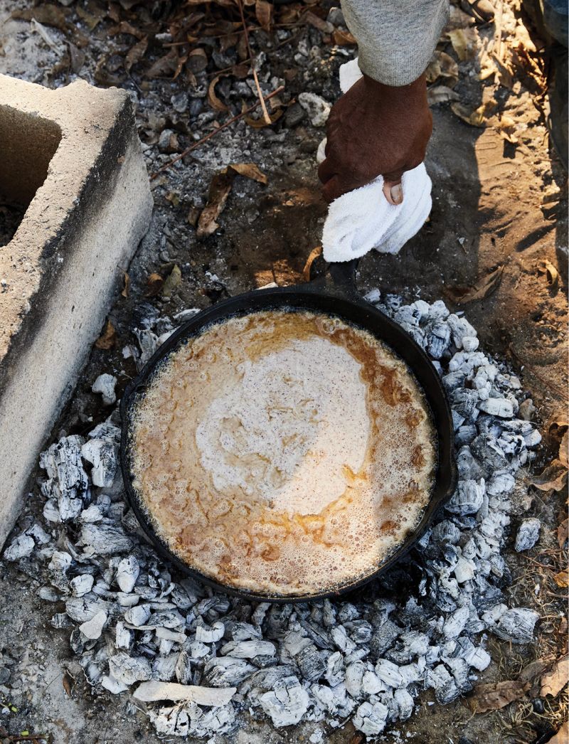 Corn bread cooking over the coals.