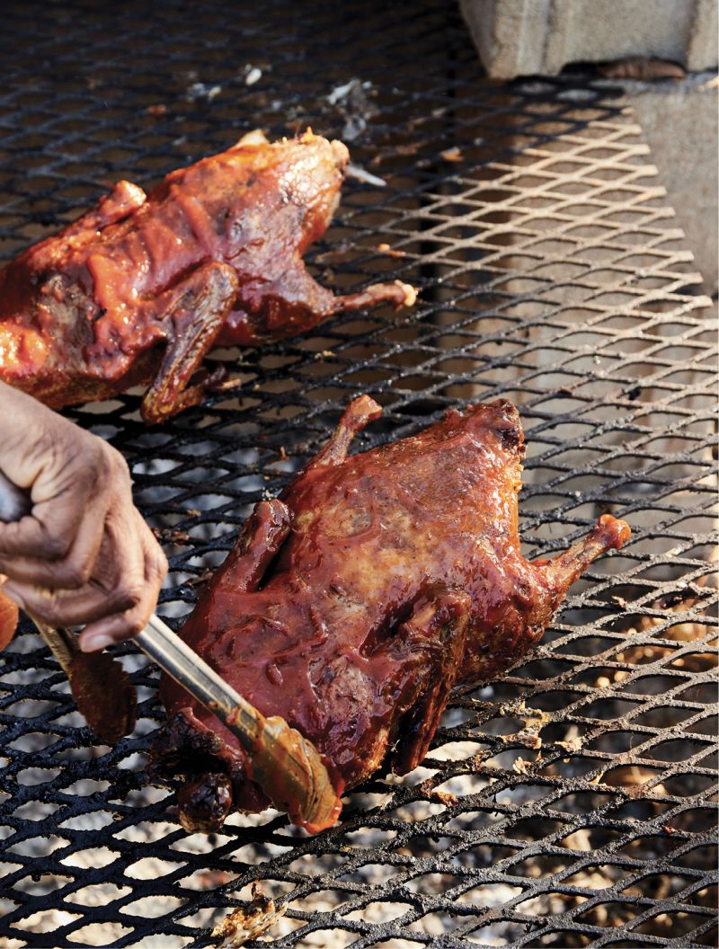 Putting the final touches on his roasted ducks.