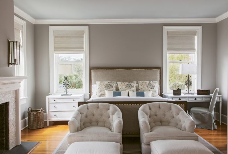 Neutral Territory: For the master bedroom, Peake worked with a neutral palette conducive to relaxation: Benjamin Moore “Cumulus Cloud” covers the walls, with “Half Moon Crest” on the ceiling. The custom headboard was upholstered in Belgian linen. Natural woven shades provide privacy while still allowing for natural light.
