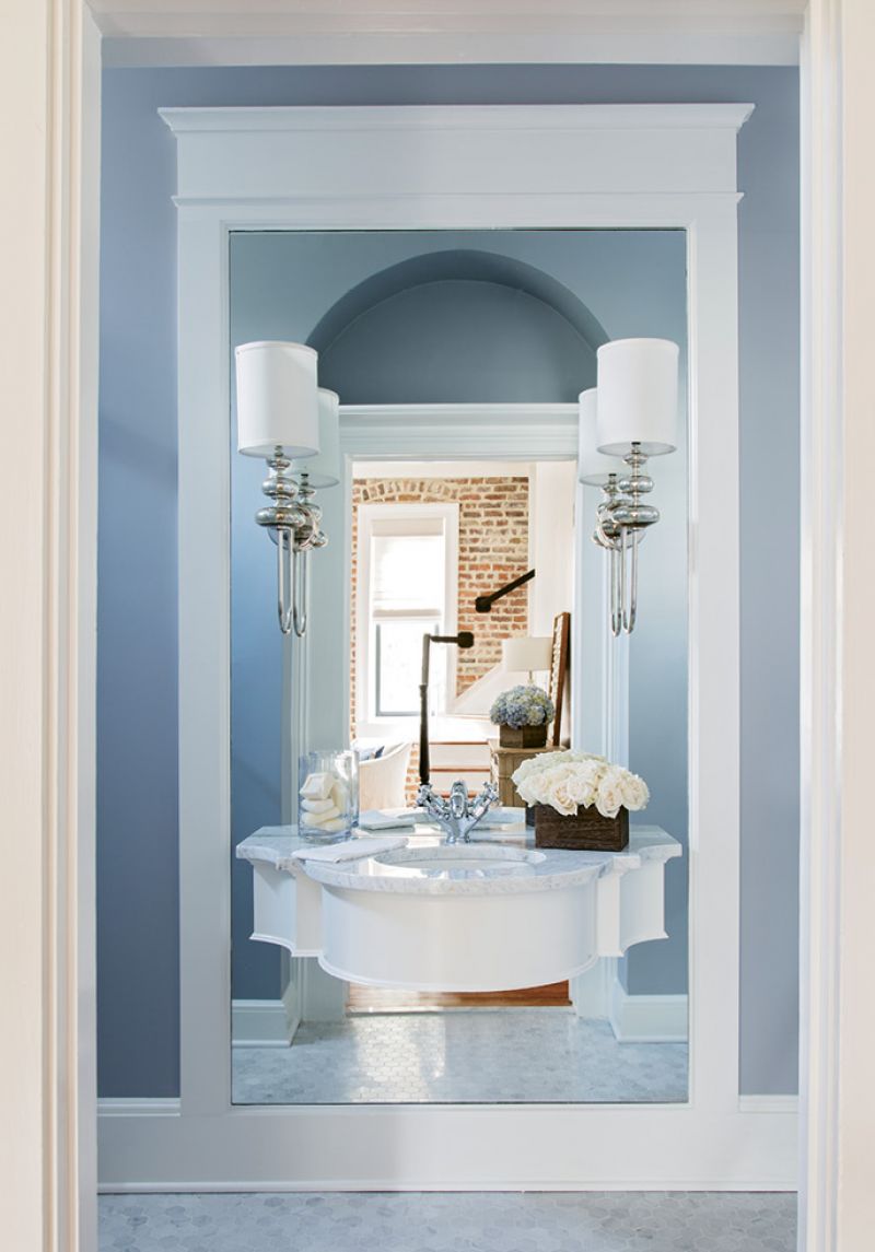 Optical Illusion: As the powder room lacked the depth for a vanity, Peake floated the sink on a mirrored wall, giving the petite space some wow factor.
