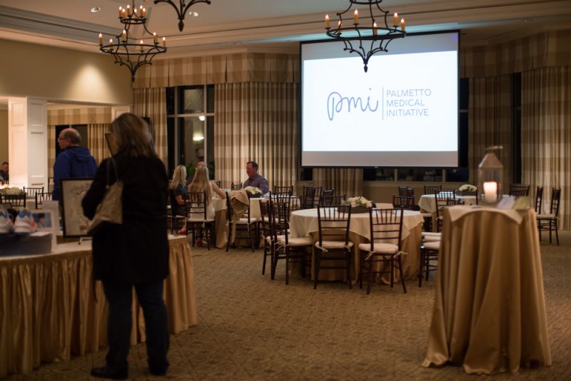 Two large projectors played slides about Palmetto Medical Initiative and their mission.