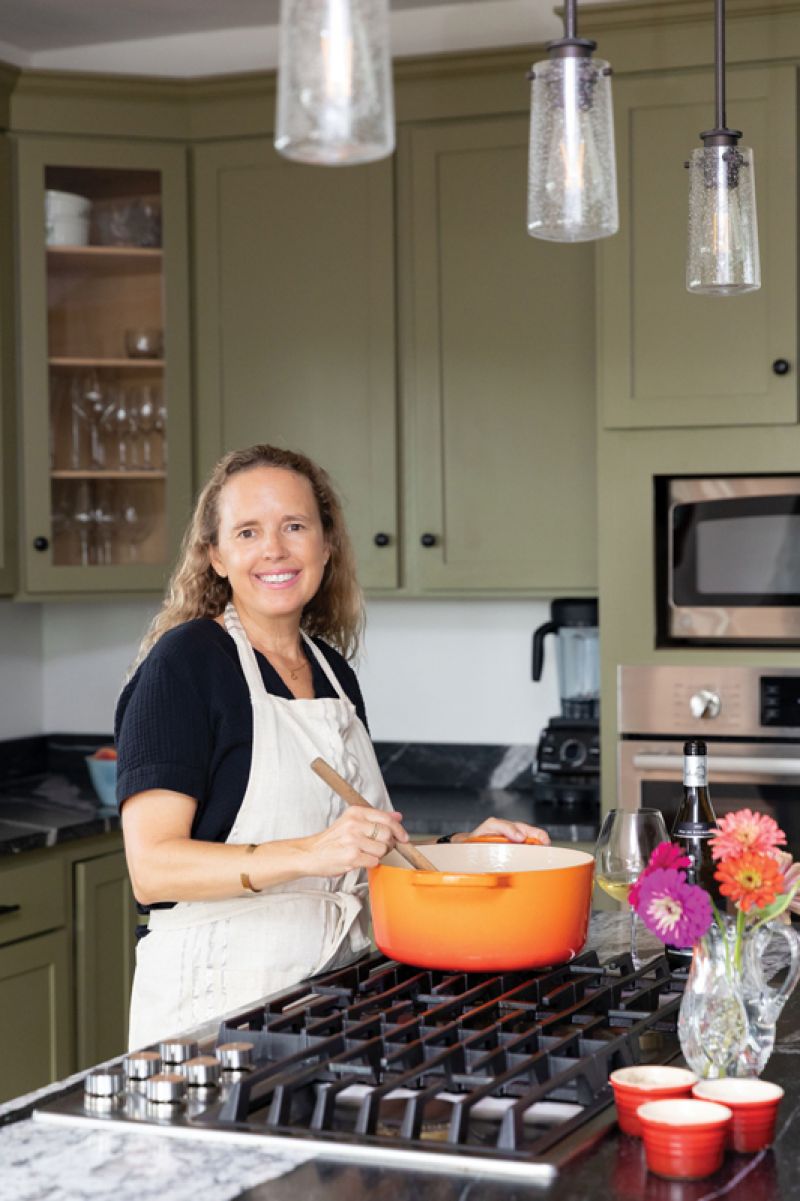 The writer, restaurateur, and sommelier in her kitchen, testing her shrimp and white bean recipe.