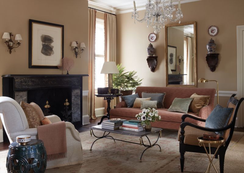 Rosy Outlook: The “Paige” sofa from Kerry Joyce upholstered in rose velvet adds warmth to the formal living room, where neutral colors provide a cozy space. This was originally the dining room, and the homeowners decided to switch the uses to create more living space in the back of the elongated house.