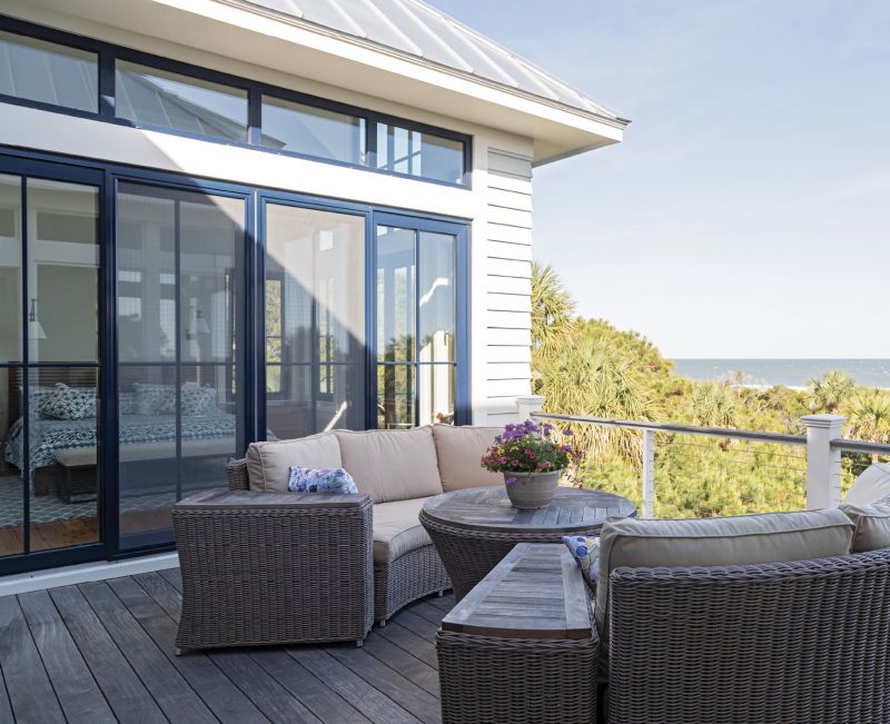 Shades do grace the windows adjoining the cozy porch space, where their children, when visiting, like to play board games.
