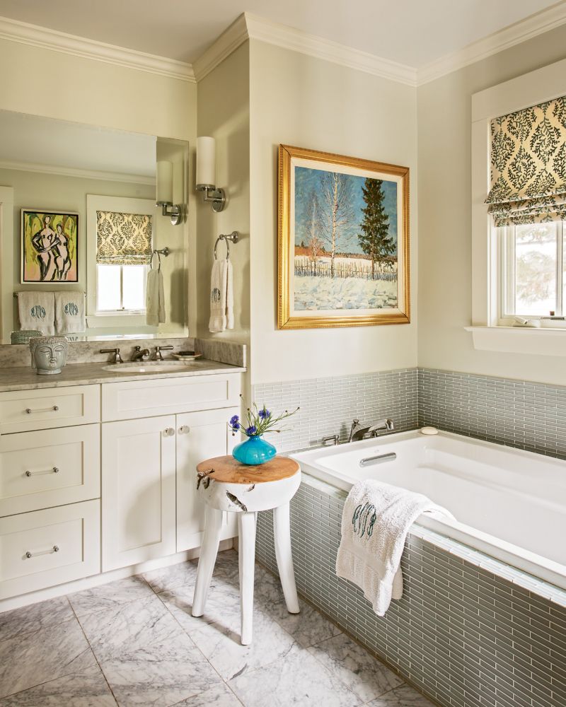 A piece by Charleston Artist Collective artist Anne Darby Parker reflects in the bath mirror.